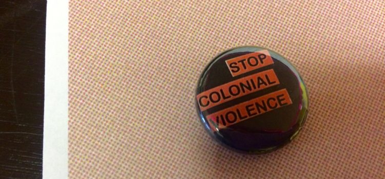 Decolonization workshop, a video from Unist’ot’en Camp 2014 button that says "stop colonial violence"