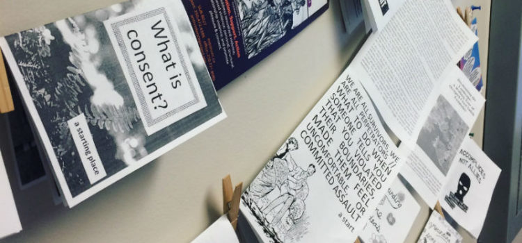Fall 2018 Term Summary Photo of strands of zines hung up against a wall.