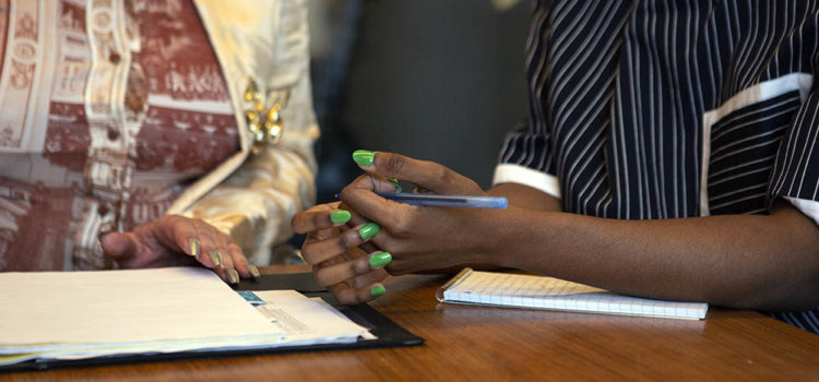 Volunteer with us! Photo of two colleagues in a meeting.