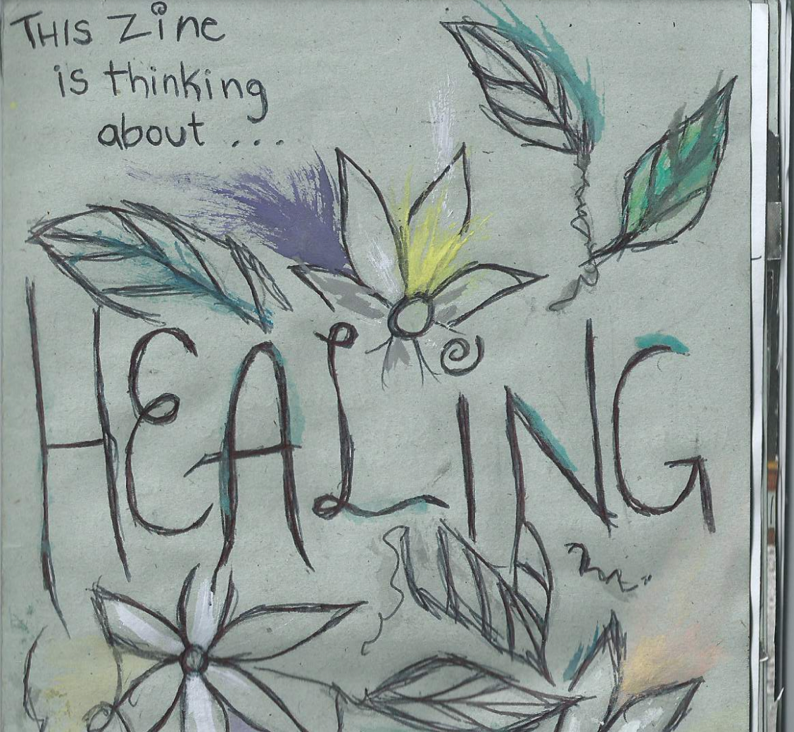 the front cover of the healing zine. a grey-green background with drawings of flowers and leaves poking out like a sunset from the words "healing"