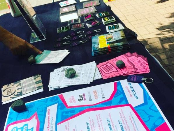 A photo of a table covered in outreach supplies including posters, handbills, stickers and brochures